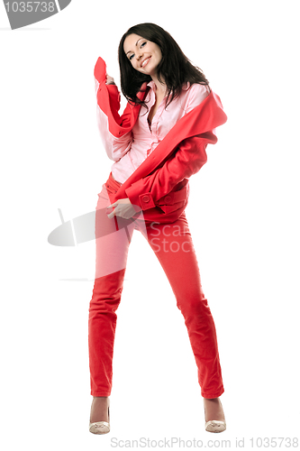 Image of Happy young brunette in red suit. Isolated