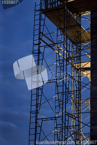 Image of construction scaffolding against nighttime sky