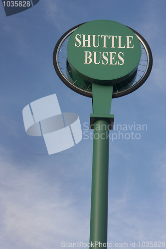 Image of shuttle buses sign against blue sky