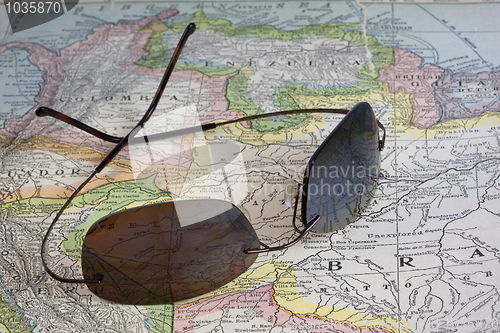 Image of sun glasses over vintage map of South America