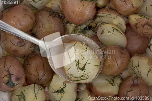 Image of freshly cooked new red potatoes with tablespoon