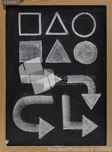 Image of geometrical shapes and arrow - white chalk on blackboard