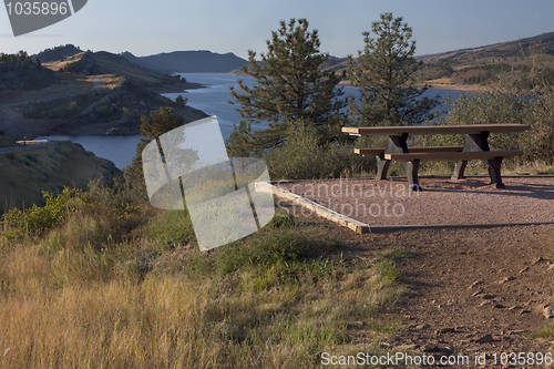 Image of picnic table on shore of mountain reservoir