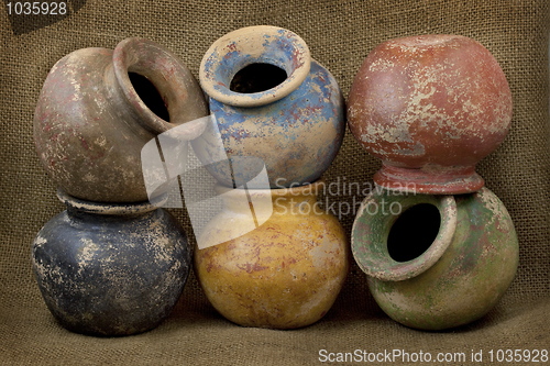 Image of six clay plant pots with grunge finish