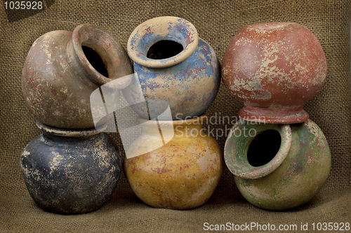 Image of six clay plant pots with grunge finish