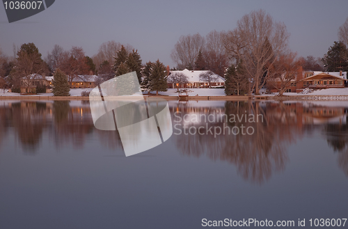 Image of luxury houses on a lake shore at dusk