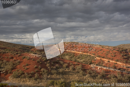 Image of desert hilly landscape under stormy sky