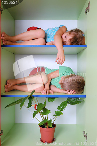 Image of tired kids in a closet