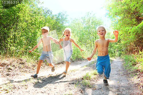 Image of happy kids running in the woods