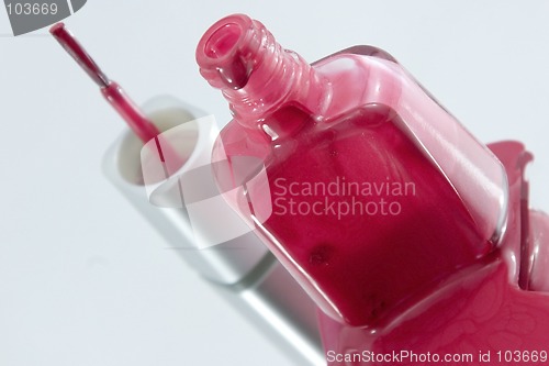 Image of Nail Polish Spilling on a Mirror with the Brush Standing at an A