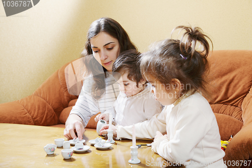 Image of Mummy playing with daughters at home