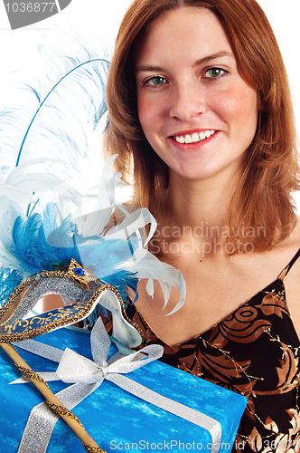 Image of  Portrait of the young woman in a carnival to a mask, a close up