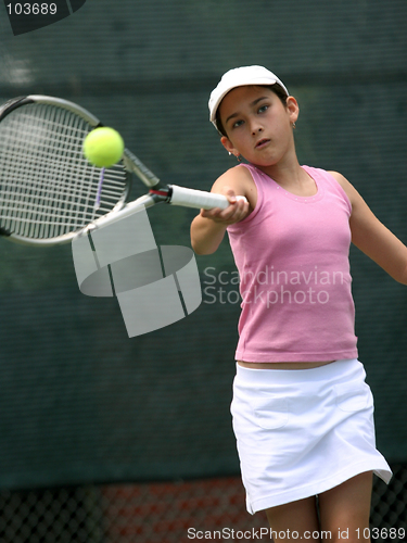 Image of Young girl playing tennis