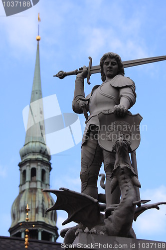 Image of Statue of Saint George and tower of Dome Church in Riga