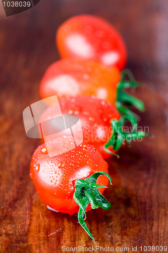 Image of four wet tomatoes