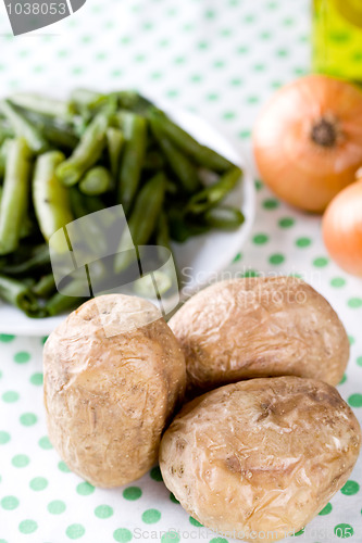 Image of baked potatoes and french beans
