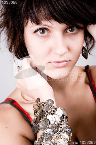 Image of young brunette lady with bracelets