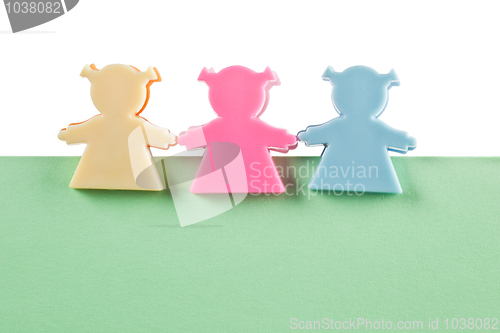 Image of 3 female figurines on blank paper