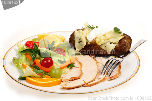 Image of Sliced turkey and salad meal side view