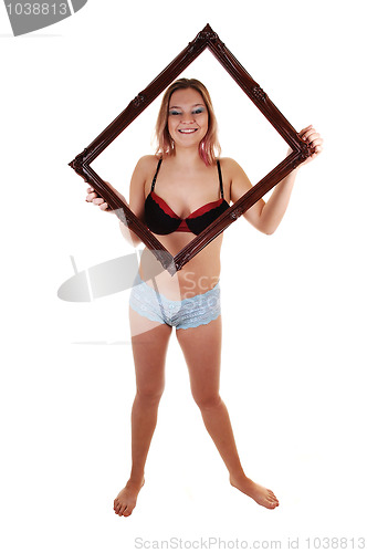 Image of Girl holding frame up.
