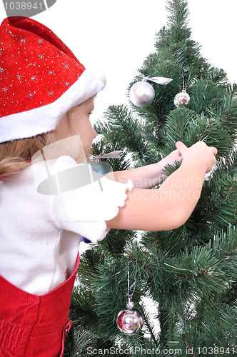 Image of child decorating Christmas tree