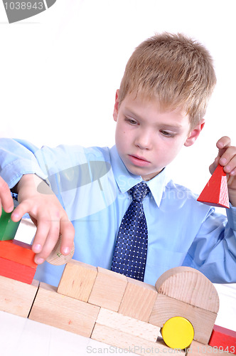 Image of schoolboy playing with bricks