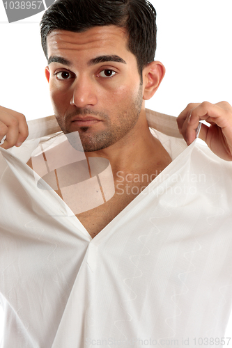 Image of Handsome man removing shirt