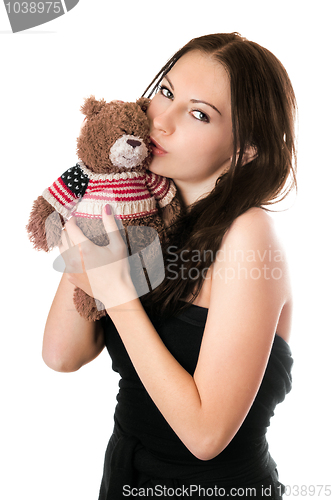 Image of Young woman kissing teddy-bear