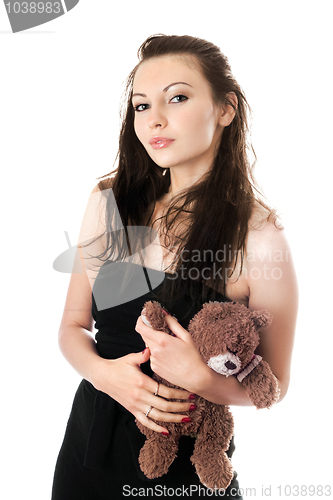 Image of Playful woman taking teddy-bear