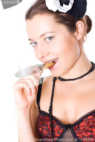 Image of woman in corset and little hat eating cookie