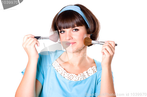 Image of brunette woman with two make-up brushes 