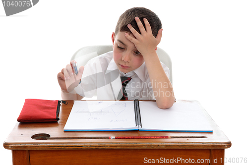 Image of Boy thinkinhg at school desk