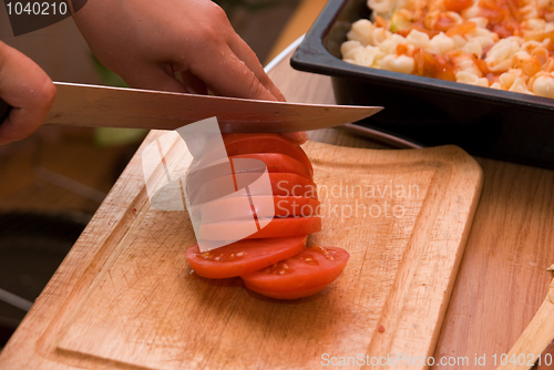 Image of Cutting red tomato