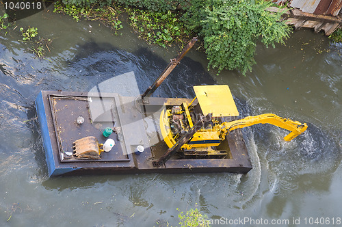 Image of Small dredge doing maintenance on a canal