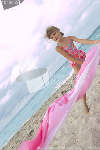 Image of child playing with  at the beach