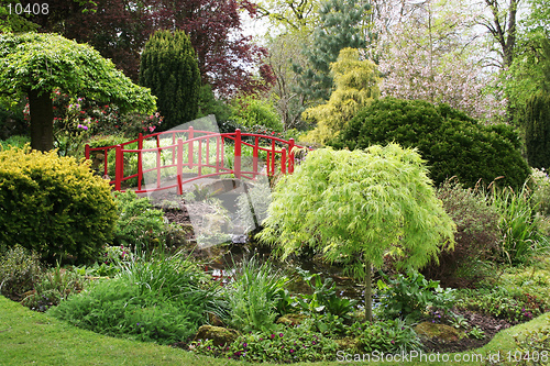 Image of A bridge over a pond in a beautiful English garden