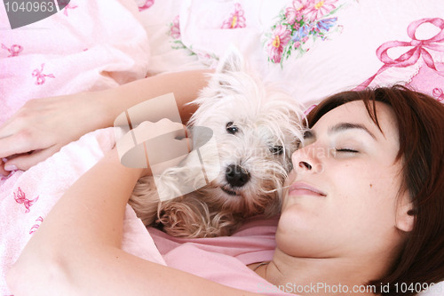 Image of Dog sleeping on bed 