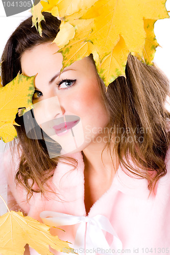 Image of beautiful young woman with yellow leaves 