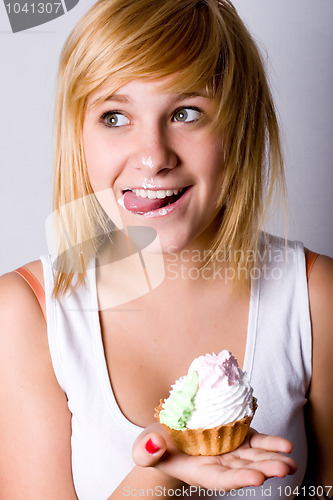 Image of funny young woman with cake 