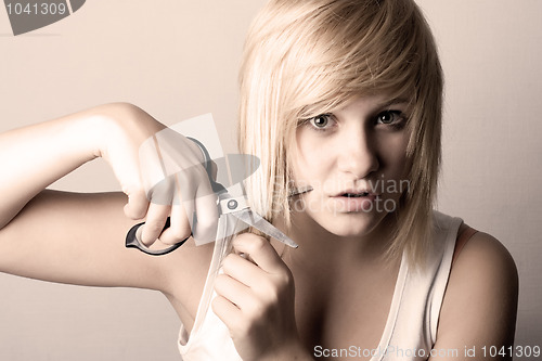 Image of young woman with scissors