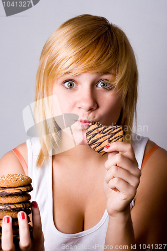 Image of woman eating chocolate chip cookies