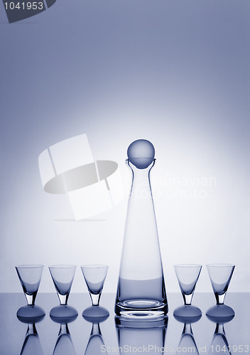 Image of Decanter and five glasses backlit and blue-toned