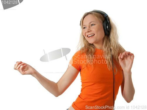 Image of Happy girl listening to music and dancing