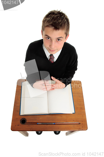 Image of School boy sitting at school desk