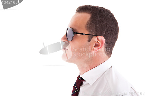 Image of young business man in profile, with sunglasses