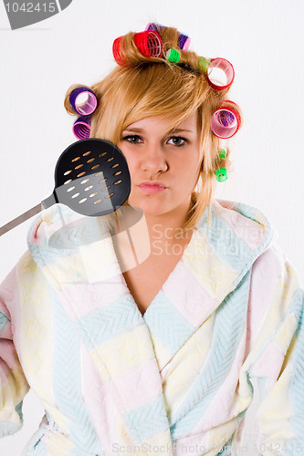 Image of funny housewife with curlers and skimmer