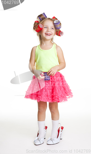 Image of Little girl play fashion in mothers shoes and rollers