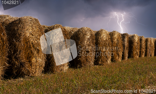 Image of haystacks in the field during the thunderstorm