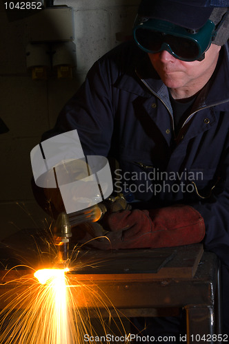 Image of Close up of welder with orange sparks