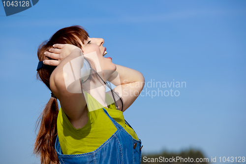 Image of Happy woman listen music